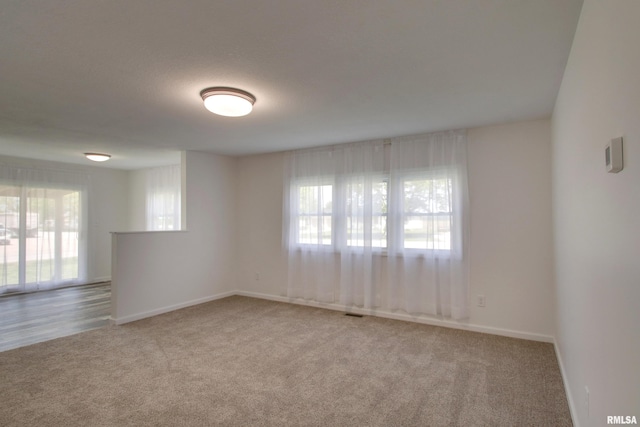 empty room with carpet and baseboards