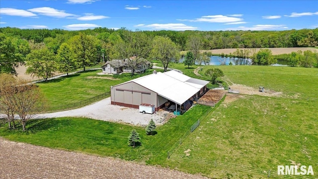 view from above of property featuring a large body of water and a heavily wooded area