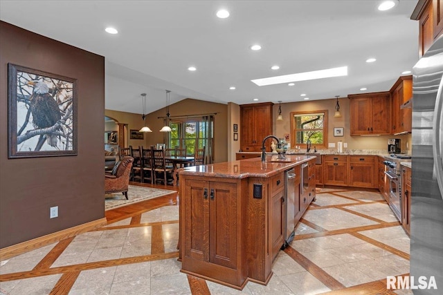 kitchen with inlaid floor details, brown cabinets, light stone counters, plenty of natural light, and recessed lighting
