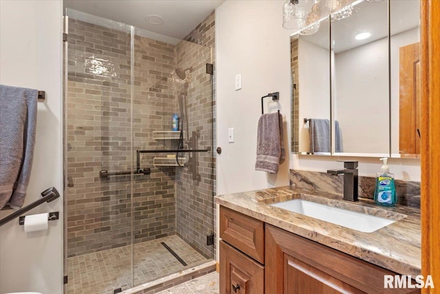 full bath featuring a stall shower and vanity