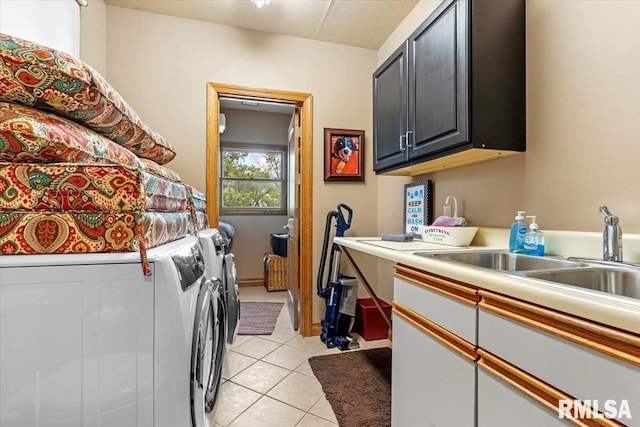 laundry room with cabinet space, washer and clothes dryer, and light tile patterned flooring