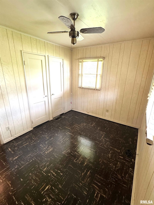 461 W Fremont St, Galesburg, IL 61401 - unfurnished room featuring wooden walls and a ceiling fan