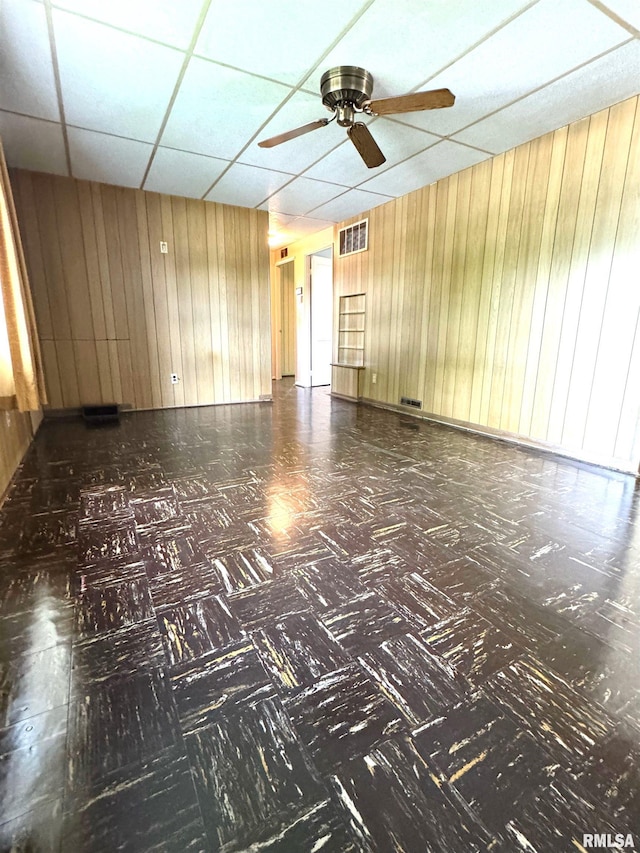 461 W Fremont St, Galesburg, IL 61401 - spare room with wood walls, a paneled ceiling, and ceiling fan