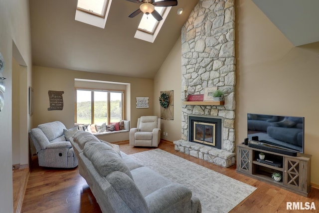 4629 Hidden Cove Rd, Quincy, IL 62305 - living area featuring high vaulted ceiling, a fireplace, ceiling fan, wood finished floors, and a skylight
