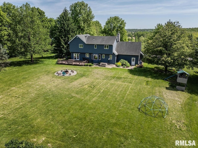 4629 Hidden Cove Rd, Quincy, IL 62305 - rear view of house featuring an outdoor fire pit, a wooden deck, a yard, and a chimney