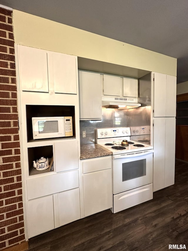 810 NW 7th Ave, Galva, IL 61434 - kitchen with white appliances, under cabinet range hood, dark wood-style flooring, and white cabinets