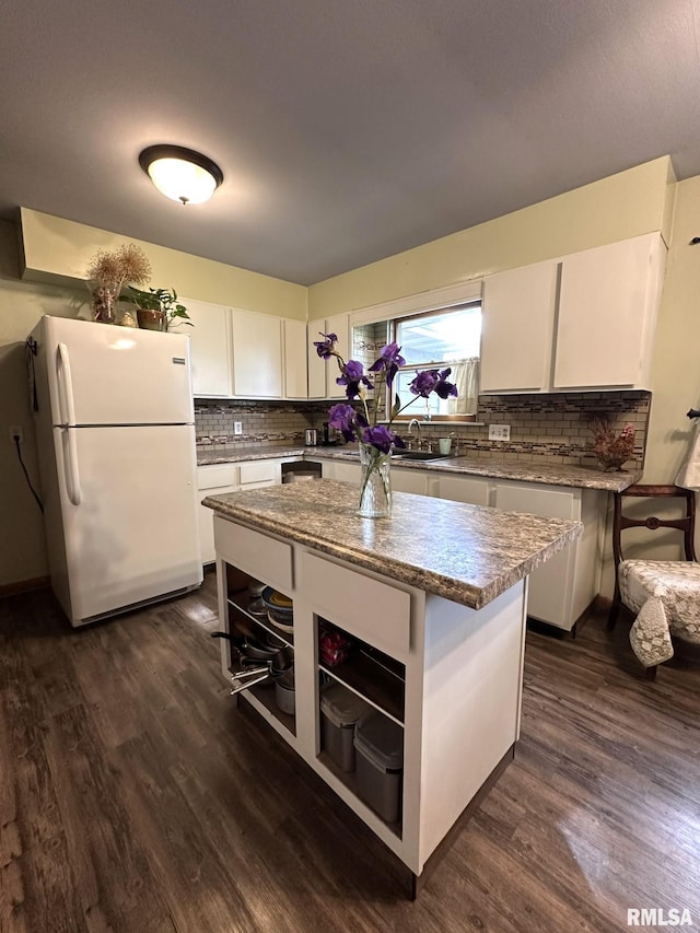 810 NW 7th Ave, Galva, IL 61434 - kitchen with freestanding refrigerator, open shelves, dark wood-style flooring, and backsplash