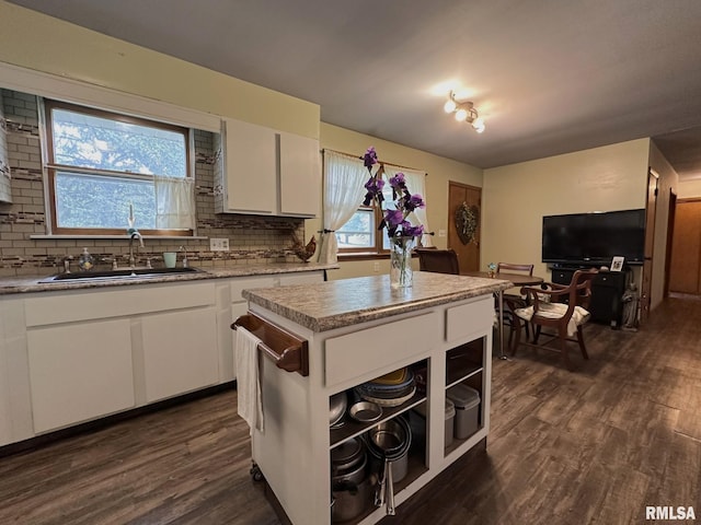 810 NW 7th Ave, Galva, IL 61434 - kitchen with a sink, dark wood-style flooring, decorative backsplash, and white cabinets