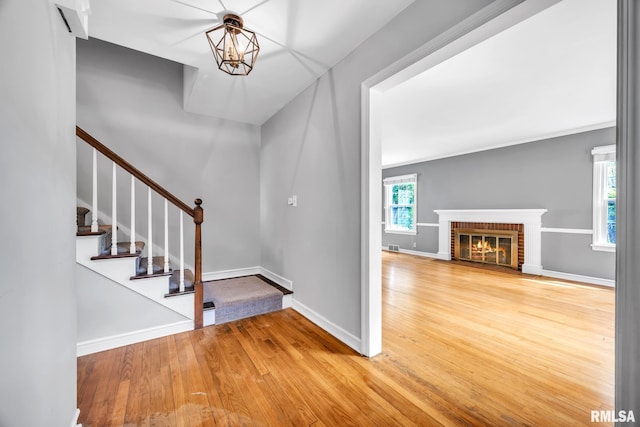2255 N Broad St, Galesburg, IL 61401 - entrance foyer featuring wood finished floors, stairway, baseboards, and a fireplace