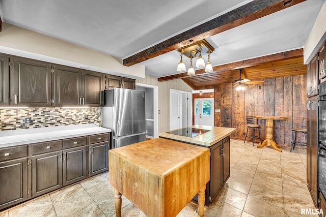 2255 N Broad St, Galesburg, IL 61401 - kitchen with freestanding refrigerator, wood walls, butcher block counters, beamed ceiling, and a center island