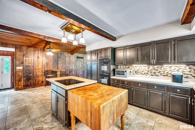 2255 N Broad St, Galesburg, IL 61401 - kitchen with black appliances, beamed ceiling, decorative backsplash, a kitchen island, and a ceiling fan