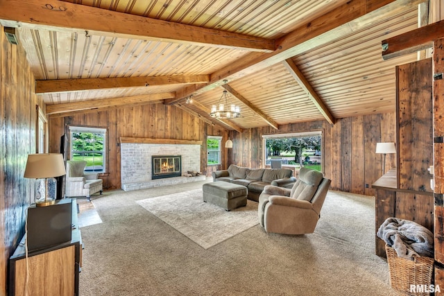 2255 N Broad St, Galesburg, IL 61401 - carpeted living room featuring plenty of natural light, a chandelier, wood walls, wood ceiling, and a fireplace