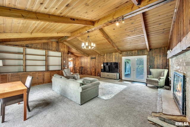 2255 N Broad St, Galesburg, IL 61401 - carpeted living area featuring a glass covered fireplace, a chandelier, wooden ceiling, and wood walls