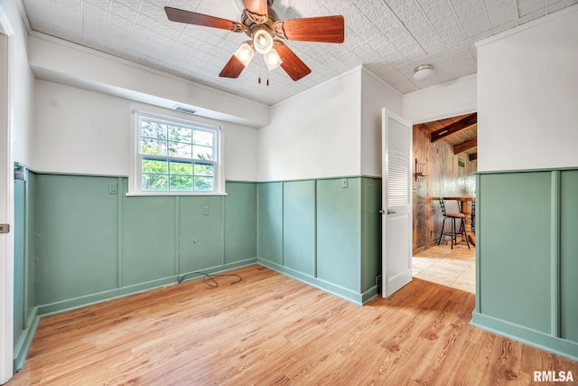 2255 N Broad St, Galesburg, IL 61401 - unfurnished room with wood finished floors, a ceiling fan, and a wainscoted wall