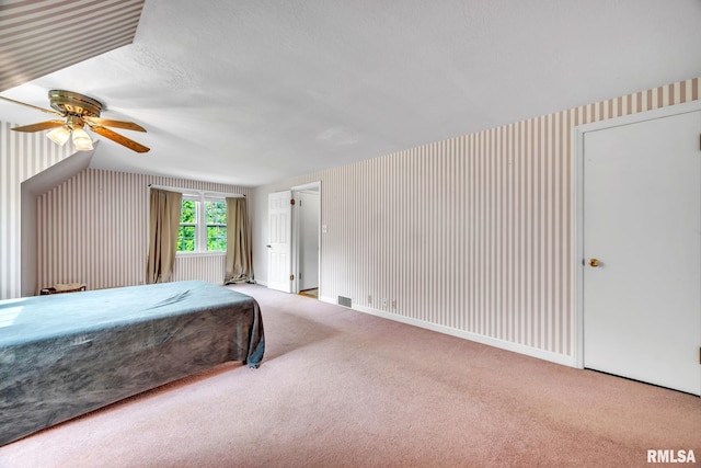 2255 N Broad St, Galesburg, IL 61401 - carpeted bedroom featuring a ceiling fan, vaulted ceiling, and wallpapered walls