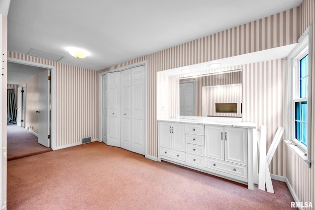 2255 N Broad St, Galesburg, IL 61401 - unfurnished bedroom with wallpapered walls, light carpet, a closet, and baseboards