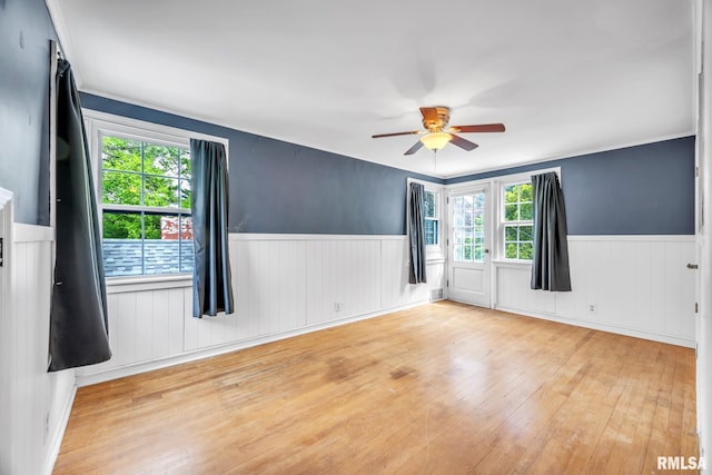 2255 N Broad St, Galesburg, IL 61401 - spare room with wainscoting, hardwood / wood-style floors, plenty of natural light, and a ceiling fan