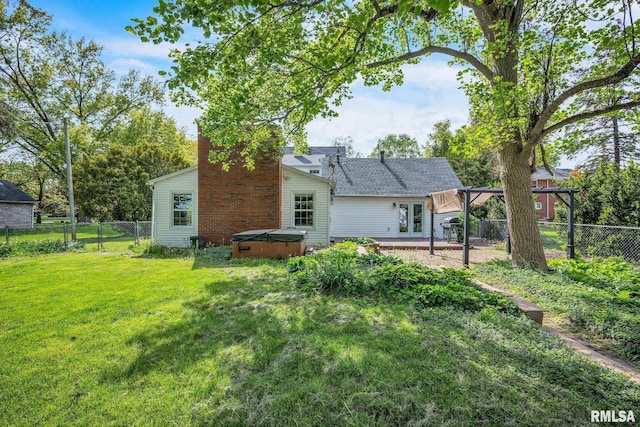 2255 N Broad St, Galesburg, IL 61401 - back of house featuring a hot tub, a chimney, and a patio