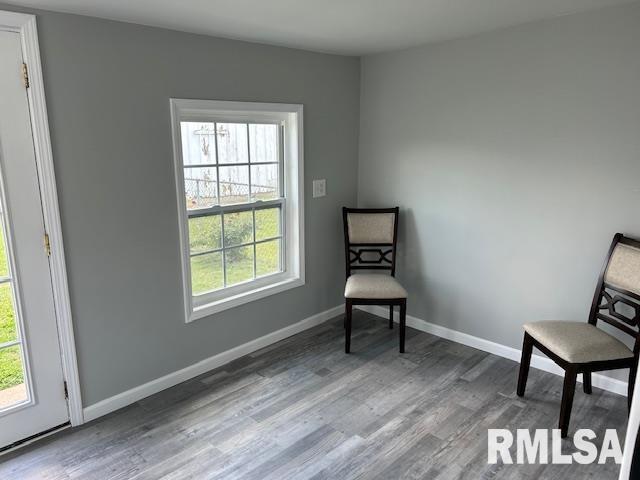 818 Van Buren St, Quincy, IL 62301 - living area featuring plenty of natural light, wood finished floors, and baseboards