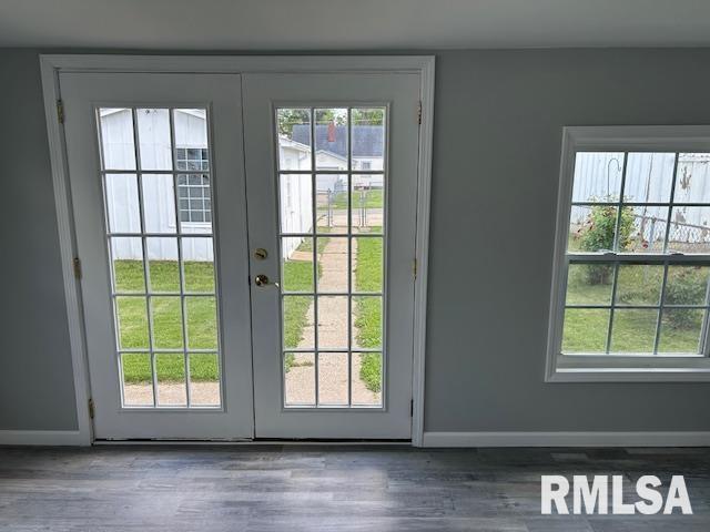 818 Van Buren St, Quincy, IL 62301 - entryway with french doors, wood finished floors, and baseboards