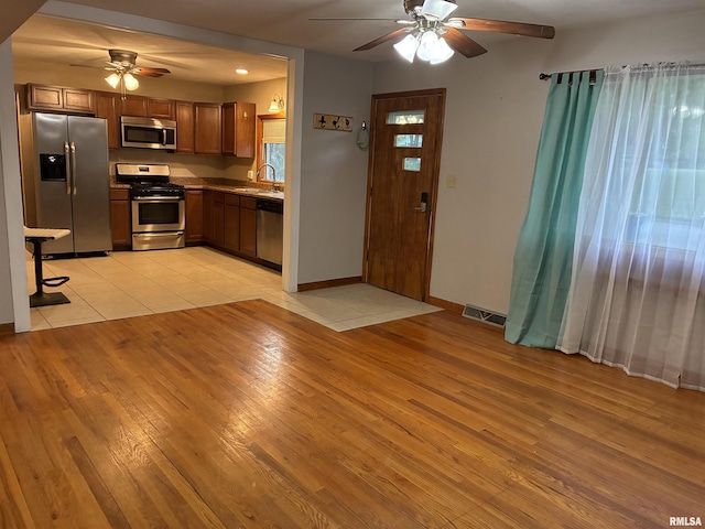1744 Jackson St, Quincy, IL 62301 - kitchen featuring appliances with stainless steel finishes, ceiling fan, light wood-style flooring, and a sink