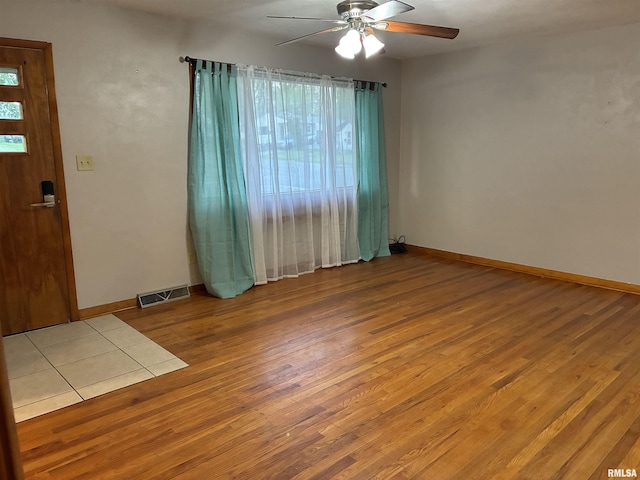 1744 Jackson St, Quincy, IL 62301 - empty room with a ceiling fan, wood finished floors, and baseboards