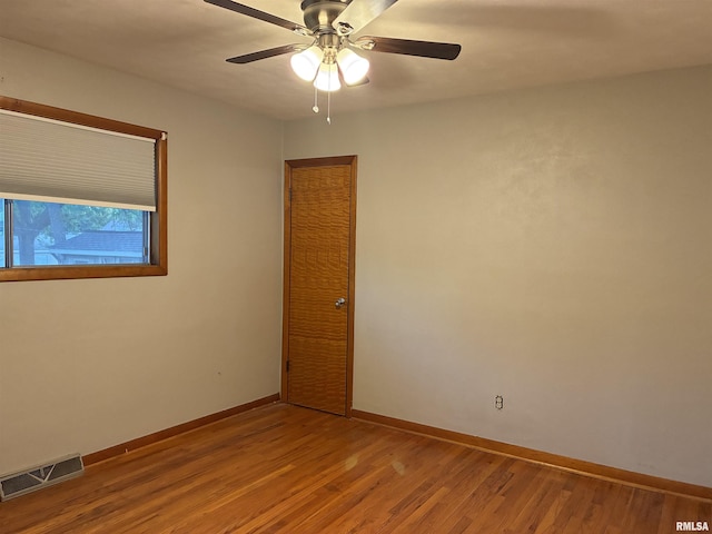 1744 Jackson St, Quincy, IL 62301 - spare room featuring wood finished floors, a ceiling fan, and baseboards