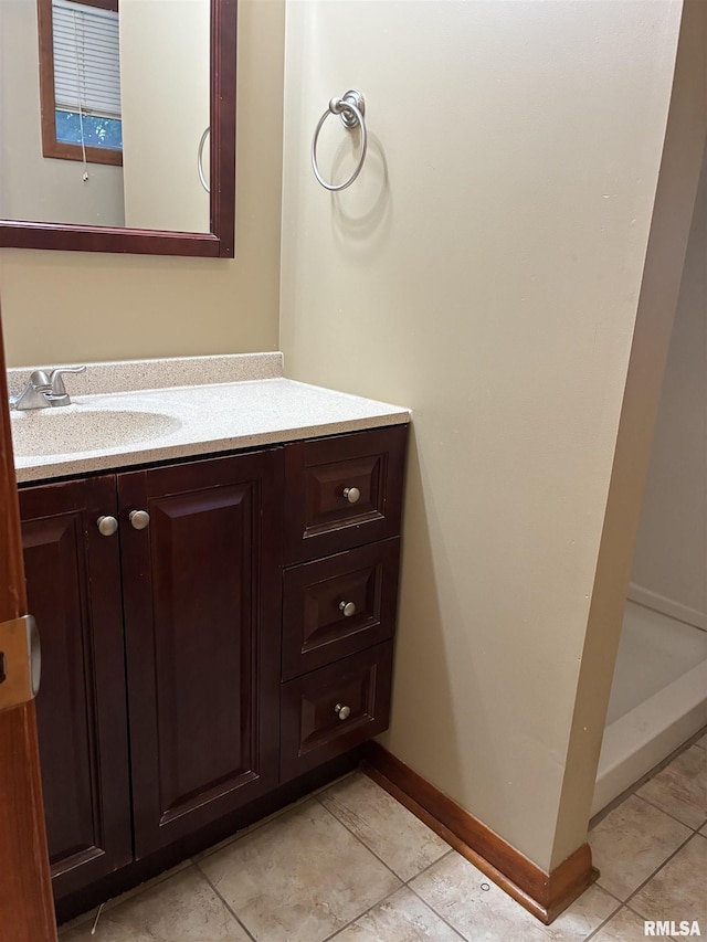 1744 Jackson St, Quincy, IL 62301 - bathroom featuring vanity, tile patterned flooring, and baseboards