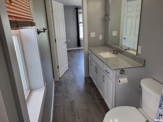 718 Adams St, Quincy, IL 62301 - bathroom featuring toilet, wood finished floors, vanity, and baseboards