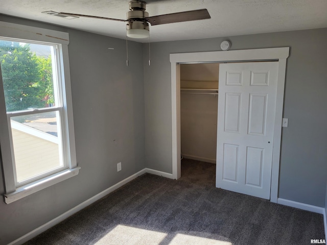 718 Adams St, Quincy, IL 62301 - unfurnished bedroom with dark colored carpet, a closet, baseboards, and ceiling fan