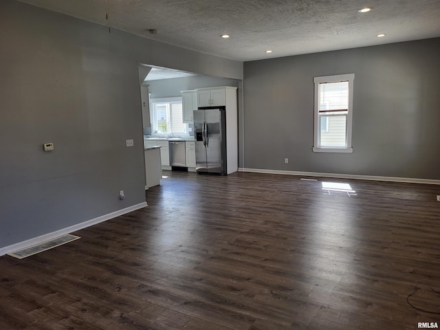 718 Adams St, Quincy, IL 62301 - unfurnished living room featuring baseboards, dark wood finished floors, recessed lighting, and a textured ceiling