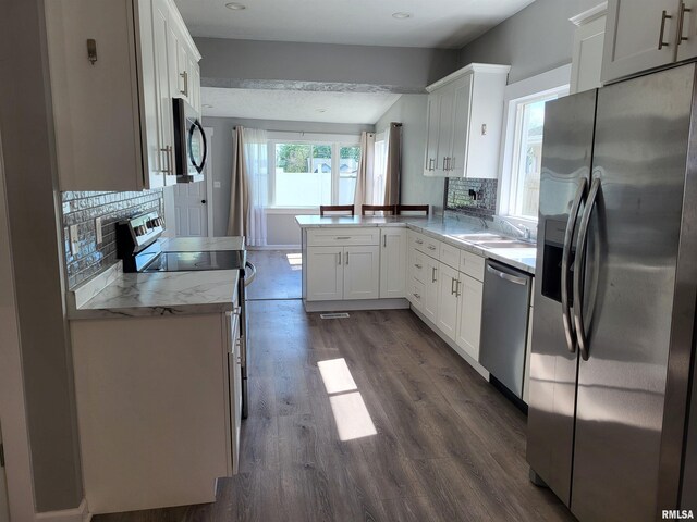 718 Adams St, Quincy, IL 62301 - kitchen with appliances with stainless steel finishes, a peninsula, dark wood-style floors, white cabinets, and a sink