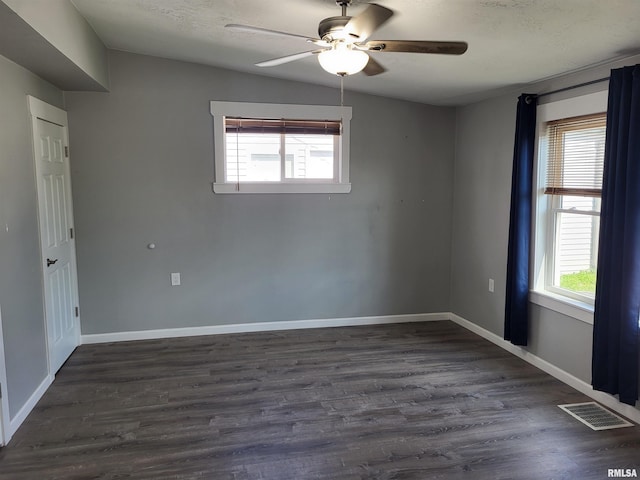 718 Adams St, Quincy, IL 62301 - spare room featuring ceiling fan, dark wood finished floors, and baseboards