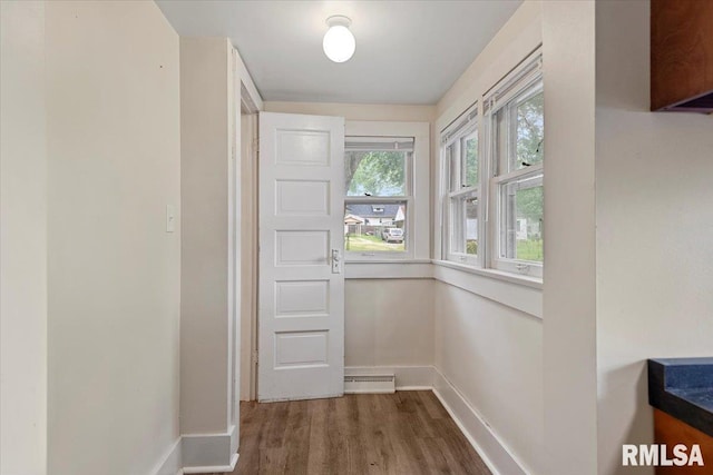708 E 5th St, Pana, IL 62557 - doorway to outside with baseboards and wood finished floors
