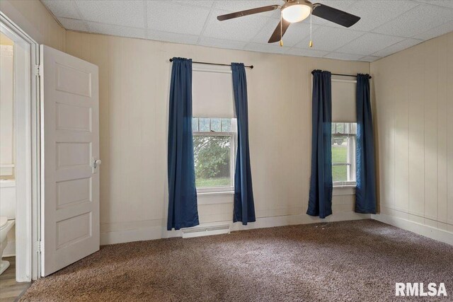 708 E 5th St, Pana, IL 62557 - empty room with carpet floors, healthy amount of natural light, and a ceiling fan