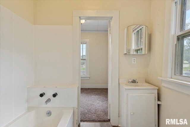 708 E 5th St, Pana, IL 62557 - full bath with vanity, healthy amount of natural light, and a bath