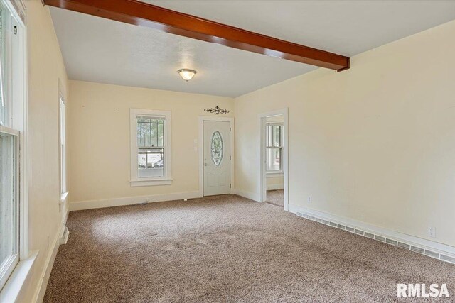 708 E 5th St, Pana, IL 62557 - carpeted spare room featuring beam ceiling and a baseboard heating unit
