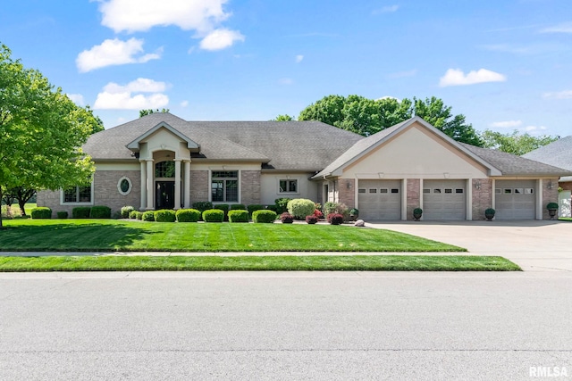 4901 Wildcat Run, Springfield, IL 62711 - view of front of property featuring a front lawn, driveway, a garage, brick siding, and a shingled roof