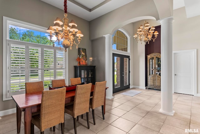 4901 Wildcat Run, Springfield, IL 62711 - dining area featuring a chandelier, decorative columns, healthy amount of natural light, a high ceiling, and arched walkways