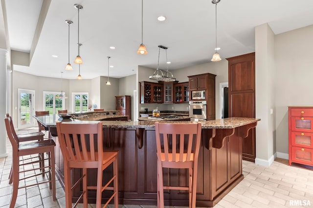 4901 Wildcat Run, Springfield, IL 62711 - kitchen featuring baseboards, glass insert cabinets, stainless steel appliances, recessed lighting, and a breakfast bar area