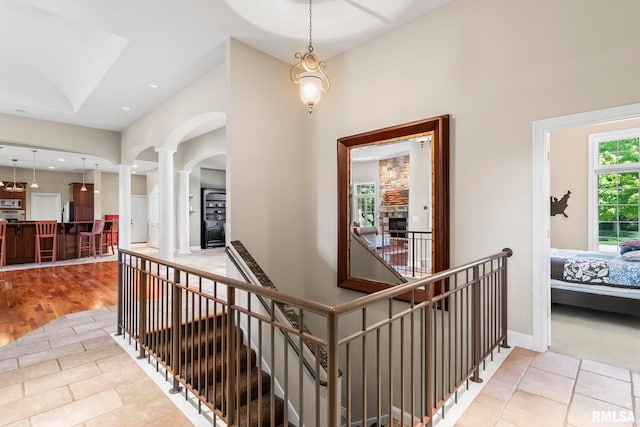 4901 Wildcat Run, Springfield, IL 62711 - hallway with ornate columns, an upstairs landing, arched walkways, a towering ceiling, and baseboards