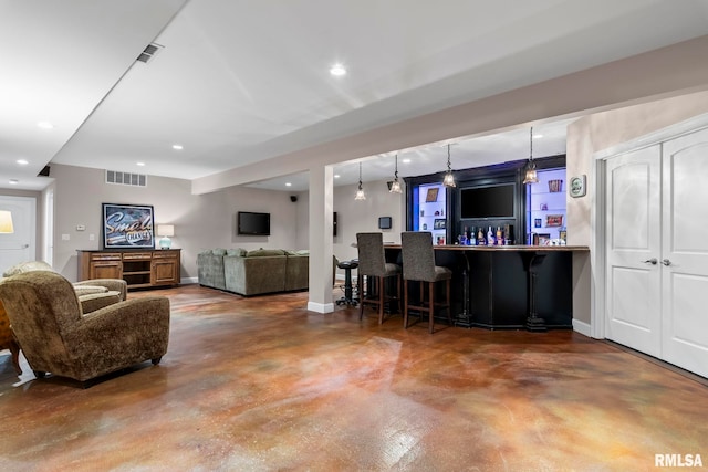 4901 Wildcat Run, Springfield, IL 62711 - living area featuring concrete floors, a bar, baseboards, and recessed lighting