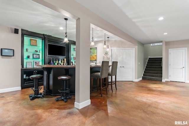 4901 Wildcat Run, Springfield, IL 62711 - indoor wet bar with finished concrete flooring, baseboards, stairs, recessed lighting, and pendant lighting