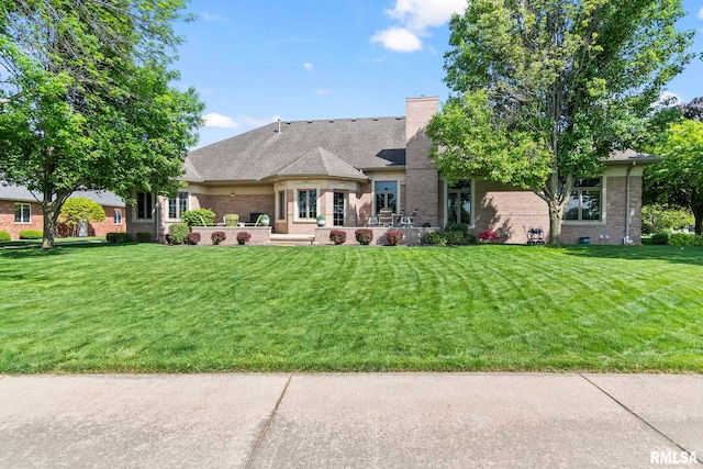 4901 Wildcat Run, Springfield, IL 62711 - rear view of property with brick siding, a lawn, a patio, and a chimney
