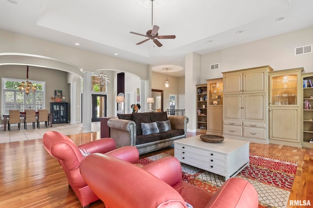 4901 Wildcat Run, Springfield, IL 62711 - living area featuring ornate columns, arched walkways, recessed lighting, a tray ceiling, and ceiling fan