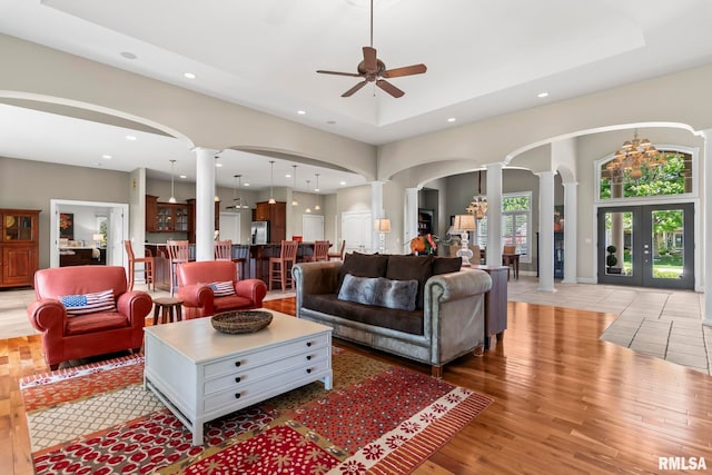 4901 Wildcat Run, Springfield, IL 62711 - living room with ornate columns, arched walkways, recessed lighting, ceiling fan, and a tray ceiling