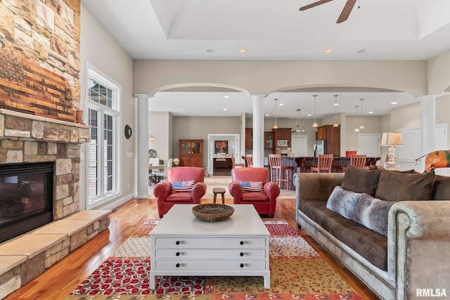 4901 Wildcat Run, Springfield, IL 62711 - living area featuring ornate columns, arched walkways, light wood-style floors, ceiling fan, and recessed lighting