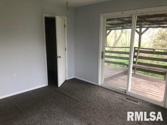 1522 Rim Rd, Quincy, IL 62305 - spare room with dark carpet and baseboards