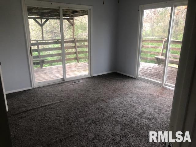1522 Rim Rd, Quincy, IL 62305 - unfurnished room with healthy amount of natural light, carpet floors, and baseboards