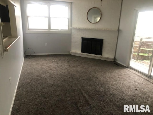 1522 Rim Rd, Quincy, IL 62305 - unfurnished living room with carpet floors, healthy amount of natural light, and a brick fireplace
